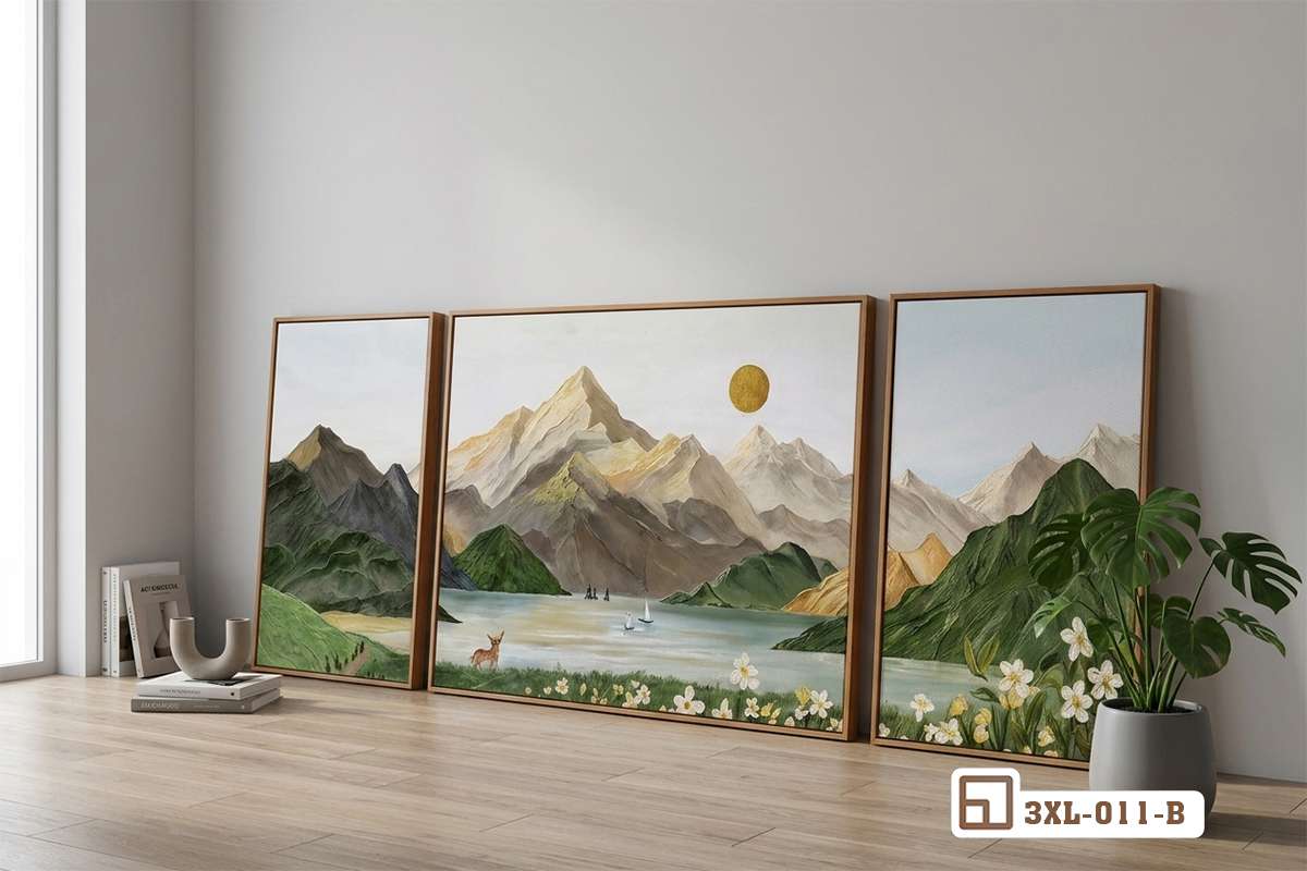 tranh phong cảnh sơn thủy đặt sát sàn nhà cạnh sofa xanh ngọc và chậu cây Bức tranh phong cảnh sơn thủy khổ lớn dựng sát sàn nhà cạnh bộ sofa xanh ngọc và chậu cây xanh mát